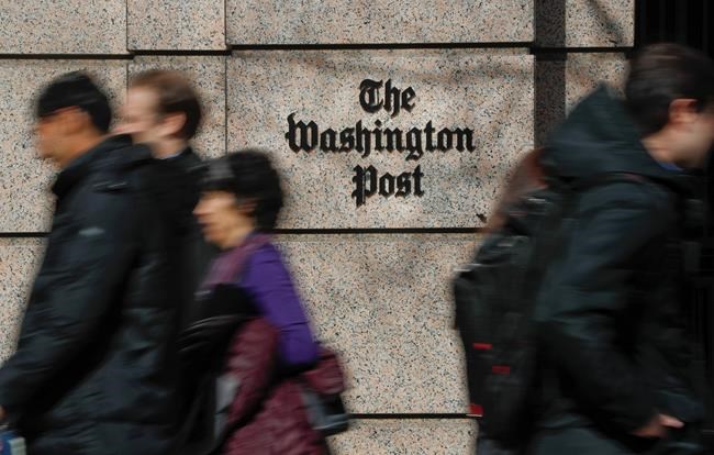 FILE - In this Thursday, Feb. 21, 2019, file photo, people walk by the One Franklin Square Building, home of The Washington Post newspaper, in downtown Washington. Washington Post political reporter Felicia Sonmez, who had been placed on administrative leave after she tweeted a link to a story about a 2003 rape allegation against Kobe Bryant, has been cleared to return to work, the paper said Tuesday, Jan. 28, 2020. (AP Photo/Pablo Martinez Monsivais, File)