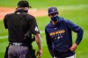 FILE - In this Monday, Sept. 14, 2020, file photo, Milwaukee Brewers manager Craig Counsell talks to umpire Ron Kulpa during the first inning of the first game of a baseball doubleheader against the St. Louis Cardinals, in Milwaukee. Counsell is confident former MVP Christian Yelich’s 2020 hitting struggles won’t carry over into next season. (AP Photo/Morry Gash, File)