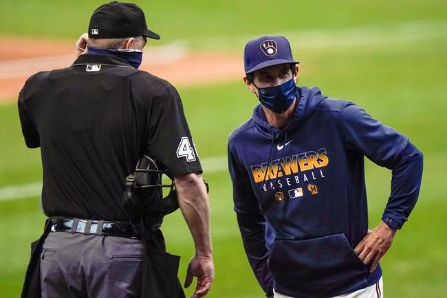 FILE - In this Monday, Sept. 14, 2020, file photo, Milwaukee Brewers manager Craig Counsell talks to umpire Ron Kulpa during the first inning of the first game of a baseball doubleheader against the St. Louis Cardinals, in Milwaukee. Counsell is confident former MVP Christian Yelich’s 2020 hitting struggles won’t carry over into next season. (AP Photo/Morry Gash, File)