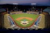FILE - In Oct. 10, 2018, file photo, Dodger Stadium is seen after sunset in Los Angeles. Dodger Stadium will serve as a vote center for the presidential election in November 2020, making the Dodgers the first Major League Baseball team to make their venue available for voting. (AP Photo/Mark J. Terrill, File)