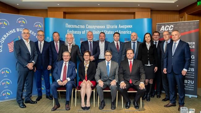 FILE - In this Nov. 12, 2018, photo provided by the U.S. Embassy in Kyiv, Ukraine, Energy Secretary Rick Perry, front center, poses for a photo after speaking in Kyiv, with front row from left: Morgan Williams; then-U.S. Ambassador to Ukraine Marie Yovanovitch; and president of the American Chamber of Commerce in Ukraine Andy Hunder. Also pictured are Alex Cranberg, top second from left, and Michael Bleyzer, top row fourth from left. Bleyzer and Cranberg, two political supporters of Perry, secured a potentially lucrative oil-and-gas exploration deal from the Ukrainian government soon after Perry proposed one of the men as an adviser to the country's new president. (U.S. Embassy Kyiv via AP, File)