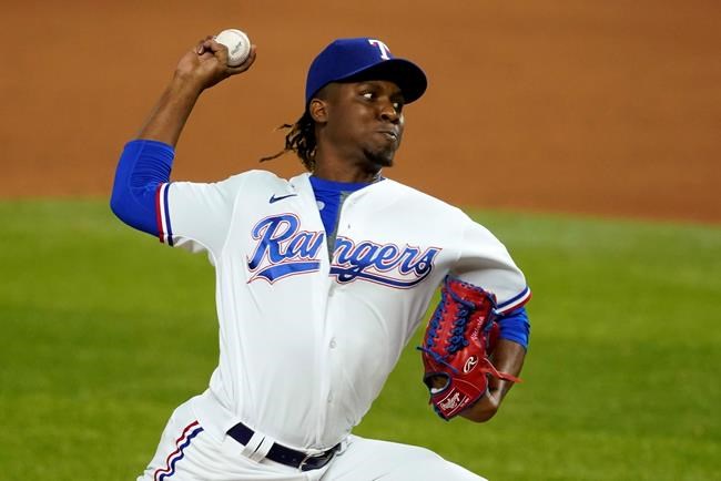 File-This Sept. 9, 2020, file photo shows Texas Rangers relief pitcher Rafael Montero throwing to the Los Angeles Angels in a baseball game in Arlington, Texas. The Seattle Mariners bolstered their bullpen on Tuesday by acquiring right-handed reliever Montero from the Rangers. (AP Photo/Tony Gutierrez, File)