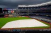 Storm clouds move over a tarp-covered field at Yankee Stadium where a baseball game between the New York Yankees and the Baltimore Orioles has been postponed due to inclement weather, Thursday, Sept. 10, 2020, in New York. The game was rescheduled for Friday afternoon as part of a doubleheader. (AP Photo/Kathy Willens)