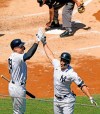 On-deck batter New York Yankees Aaron Judge, left, celebrates with Yankees designated hitter Giancarlo Stanton after Stanton hit a solo home run during the third inning of a baseball game against the Houston Astros, Thursday, May 6, 2021, at Yankee Stadium in New York. (AP Photo/Kathy Willens)