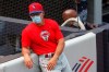Philadelphia Phillies manager Joe Girardi leans against the stands during batting practice before an exhibition baseball game against his former team, the New York Yankees, Monday, July 20, 2020, at Yankee Stadium in New York. (AP Photo/Kathy Willens)