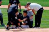 New York Yankees pitcher Masahiro Tanaka is tended to by team medical personnel after being hit by a ball off the bat of Yankees Giancarlo Stanton during a baseball a workout at Yankee Stadium in New York, Saturday, July 4, 2020. (AP Photo/Adam Hunger)