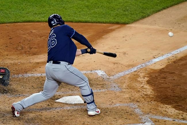 Tampa Bay Rays' Ji-Man Choi (26) hits an RBI-single during the sixth inning of a baseball game against the New York Yankees, Monday, Aug. 31, 2020, at Yankee Stadium in New York. (AP Photo/Kathy Willens)