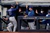 Tampa Bay Rays Joey Wendle (18) is greeted at the dugout after scoring on Yoshi Tsutsugo's RBI double during the seventh inning of a baseball game against the New York Yankees, Sunday, April 18, 2021, at Yankee Stadium in New York. (AP Photo/Kathy Willens)