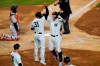 Baltimore Orioles catcher Pedro Severino, left, watches the outfield as New York Yankees designated hitter Giancarlo Stanton, right, celebrates with teammate Aaron Hicks, left, after Stanton hit a grand slam during the fifth inning of a baseball game, Monday, April 5, 2021, at Yankee Stadium in New York. (AP Photo/Kathy Willens)