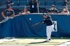 New York Yankees' Mike Tauchman, left, and Brett Gardner, second from left, watch as Gio Urshela bats in the cage during a baseball summer training camp workout Sunday, July 5, 2020, at Yankee Stadium in New York. (AP Photo/Kathy Willens)