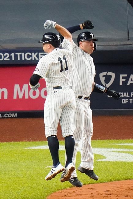 New York Yankees' Brett Gardner, left, celebrates with Gary Sanchez after they scored on a home run by Gardner during the fourth inning of a baseball game against the Toronto Blue Jays Thursday, Sept. 17, 2020, in New York. (AP Photo/Frank Franklin II)