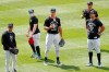 New York Yankees outfielders from left, Mike Tauchman, Clint Frazier, Aaron Judge, Brett Gardner, above right, Giancarlo Stanton, far right stand in the outfield during a workout at the Yankees summer baseball training camp, Wednesday, July 15, 2020, at Yankee Stadium in New York. (AP Photo/Kathy Willens)
