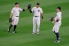 New York Yankees outfielders Brett Gardner, left, Aaron Hicks, center and Aaron Judge celebrate after the baseball game against the Boston Red Sox at Yankee Stadium, Friday, July 31, 2020, in New York. The Yankees defeated the Red Sox 5-1. (AP Photo/Seth Wenig)