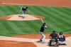 An umpire crouches as New York Yankees starting pitcher Gerrit Cole, top, delivers to Kyle Higashioka, front left, during an intrasquad game in baseball summer training camp Sunday, July 12, 2020, at Yankee Stadium in New York. (AP Photo/Kathy Willens)