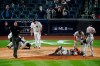 Players gather around New York Yankees' Rougned Odor (18) and Houston Astros catcher Martin Maldonado after they were injured during the sixth inning of a baseball game Tuesday, May 4, 2021, in New York. (AP Photo/Frank Franklin II)