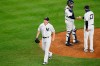 New York Yankees relief pitcher Zack Britton (53) leaves the mound after Yankees manager Aaron Boone (17) removed him during the eighth inning of a baseball game against the Tampa Bay Rays, Wednesday, Aug. 19, 2020, in New York. Boone hands the ball to New York Yankees catcher Gary Sanchez (24) who awaits the new pitcher. (AP Photo/Kathy Willens)