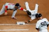 New York Yankees' Gleyber Torres (25) is caught off first by Boston Red Sox first baseman Michael Chavis (23) during the seventh inning of a baseball game Monday, Aug. 17, 2020, in New York. Yankees first base coach Reggie Willlits watches. (AP Photo/Kathy Willens)