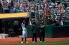 Oakland Athletics' Khris Davis raises his fist during the national anthem before a baseball game between the Athletics and the Los Angeles Angels in Oakland, Calif., Saturday, July 25, 2020. (AP Photo/Jeff Chiu)