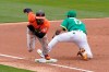 Baltimore Orioles' Cedric Mullins, left, runs past Oakland Athletics' Elvis Andrus to score after a throwing error by third baseman Matt Chapman during the third inning of a baseball game in Oakland, Calif., Saturday, May 1, 2021. (AP Photo/Jeff Chiu)