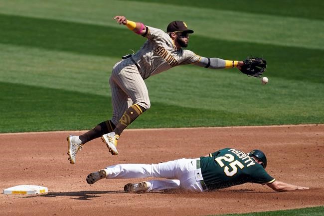 Oakland Athletics' Stephen Piscotty, bottom, steals second base under San Diego Padres shortstop Fernando Tatis Jr. during the second inning of a baseball game in Oakland, Calif., Saturday, Sept. 5, 2020. (AP Photo/Jeff Chiu)