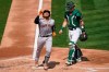 San Francisco Giants' Chadwick Tromp, left, celebrates after hitting a two-run home run next to Oakland Athletics catcher Sean Murphy during the third inning of a baseball game in Oakland, Calif., Sunday, Sept. 20, 2020. (AP Photo/Jeff Chiu)
