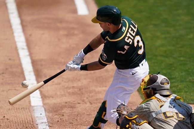 Oakland Athletics' Tommy La Stella (3) hits a run-scoring double in front of San Diego Padres catcher Austin Nola during the second inning of a baseball game in Oakland, Calif., Saturday, Sept. 5, 2020. (AP Photo/Jeff Chiu)