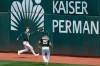 Oakland Athletics center fielder Mark Canha, left, cannot catch a two-run double hit by Houston Astros' Yuli Gurriel during the third inning of a baseball game in Oakland, Calif., Sunday, April 4, 2021. Also pictured is Athletics right fielder Stephen Piscotty (25). (AP Photo/Jeff Chiu)