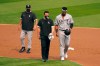 CORRECTS TO THIRD INNING NOT SECOND INNING Chicago White Sox's Eloy Jimenez, right, leaves the game with an injury next to a trainer and manager Rick Renteria, left, during the third inning of Game 3 of an American League wild-card baseball series against the Oakland Athletics, Thursday, Oct. 1, 2020, in Oakland, Calif. (AP Photo/Eric Risberg)