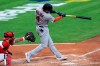St. Louis Cardinals' Yadier Molina hits an RBI sacrifice fly in the third inning of a baseball game against the Cincinnati Reds in Cincinnati, Monday, Aug. 31, 2020. (AP Photo/Aaron Doster)