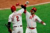 Cincinnati Reds' Nick Castellanos, left, and Tucker Barnhart celebrates Barnhart's solo home run during the third inning of the team's baseball game against the Chicago White Sox in Cincinnati, Friday, Sept. 18, 2020. (AP Photo/Aaron Doster)