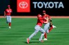 Cincinnati Reds' Mike Moustakas, front, catches a fly ball in front of Nicholas Castellanos, back, in an intrasquad game during team baseball practice at Great American Ball Park in Cincinnati, Wednesday, July 8, 2020. (AP Photo/Aaron Doster)