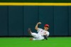 Cincinnati Reds' Shogo Akiyama slides to make a catch on a sacrifice fly hit by Milwaukee Brewers' Omar Narvaez during the seventh inning of a baseball game in Cincinnati, Saturday, July 17, 2021. (AP Photo/Aaron Doster)