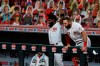 Cincinnati Reds' Brian Goodwin, left, and Curt Casali, right, react to the two-run home run hit by Eugenio Suarez in the sixth inning during a baseball game against the Milwaukee Brewers in Cincinnati, Monday, Sept. 21, 2020. (AP Photo/Aaron Doster)