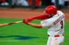 Cincinnati Reds' Mike Moustakas (9) hits a two-run home run in the seventh inning during a baseball game against the Detroit Tigers at Great American Ballpark in Cincinnati, Friday, July 24, 2020. The Reds won 7-1. (AP Photo/Aaron Doster)