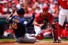 Milwaukee Brewers' Jace Peterson (14) is tagged out at home by Cincinnati Reds catcher Tucker Barnhart during the first inning of a baseball game in Cincinnati, Sunday, July 18, 2021. (AP Photo/Bryan Woolston)