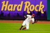 Cincinnati Reds right fielder Nicholas Castellanos (2) catches a fly ball during the first inning of a baseball game against the Chicago Cubs at Great American Ballpark in Cincinnati, Monday, July 27, 2020. (AP Photo/Bryan Woolston)