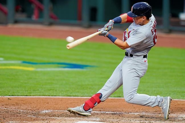 St. Louis Cardinals Tommy Edman hits an RBI double during the third inning of the team's baseball game against the Cincinnati Reds in Cincinnati, Tuesday, Sept. 1, 2020. (AP Photo/Bryan Woolston)