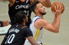 Golden State Warriors' Stephen Curry, right, goes to the basket against Cleveland Cavaliers' Darius Garland (10) in the second half of an NBA basketball game, Thursday, April 15, 2021, in Cleveland. (AP Photo/David Dermer)