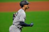 New York Yankees' Giancarlo Stanton (27) runs the bases after hitting a solo home run off Cleveland Indians relief pitcher Cam Hill (27) in the ninth inning of Game 1 of an American League wild-card baseball series, Tuesday, Sept. 29, 2020, in Cleveland. The Yankees won 12-3. (AP Photo/David Dermer)