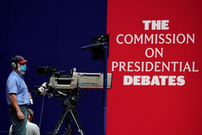 A camera operator waits for a rehearsal ahead of the first presidential debate between Republican candidate President Donald Trump and Democratic candidate former Vice President Joe Biden at the Health Education Campus of Case Western Reserve University, Monday, Sept. 28, 2020, in Cleveland. (AP Photo/Julio Cortez)