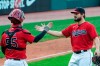 Cleveland Indians' Roberto Perez (55) greets Indians closer Brad Hand after the final out of a baseball game against the Pittsburgh Pirates in Cleveland, Sunday, Sept. 27, 2020. (AP Photo/Phil Long)