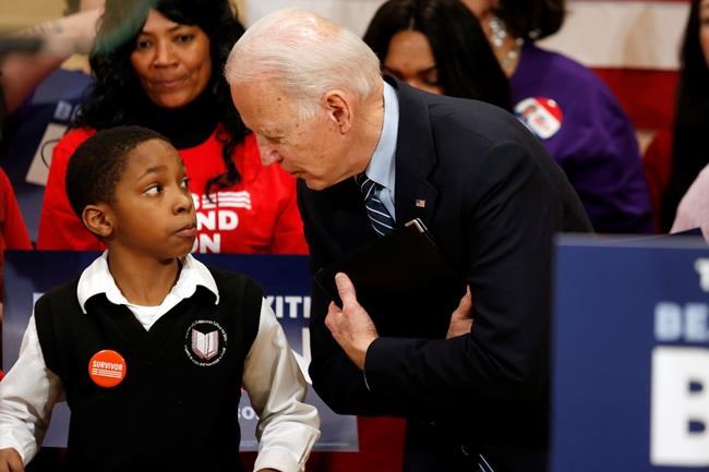 Democratic presidential candidate former Vice President Joe Biden, right, speaks with Deaunte Bell Jr., 11, of Columbus, Ohio, at a campaign event in Columbus, Ohio, Tuesday, March 10, 2020. (AP Photo/Paul Vernon)