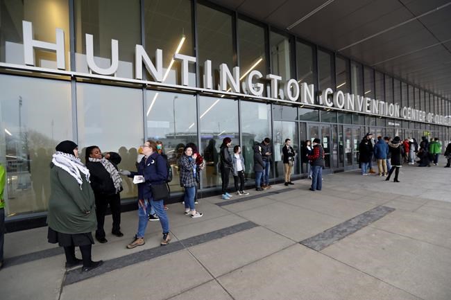 Supporters of Democratic presidential candidate Sen. Bernie Sanders, I-Vt., wait outside before a campaign rally, Tuesday, March 10, 2020, in Cleveland. The Cleveland rally was canceled due to concerns about coronavirus. (AP Photo/Tony Dejak)