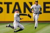 New York Yankees' Brett Gardner, left, tries to catch a ball hit by Cleveland Indians' Cesar Hernandez in the first inning in a baseball game, Thursday, April 22, 2021, in Cleveland. Gardner could not hold onto the ball for the out and Hernandez was safe with a single. (AP Photo/Tony Dejak)