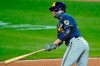 Milwaukee Brewers' Ryan Braun hits an RBI-single in the seventh inning in a baseball game against the Cleveland Indians, Friday, Sept. 4, 2020, in Cleveland. (AP Photo/Tony Dejak)