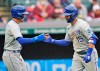 Kansas City Royals Whit Merrifield, right, is congratulated by Nicky Lopez after Merrifield hit a two-run home run in the second inning of a baseball game against the Cleveland Indians, Monday, April 5, 2021, in Cleveland. Lopez scored on the play. (AP Photo/Tony Dejak)