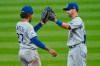 Kansas City Royals' Adalberto Mondesi, left, and Whit Merrifield celebrate after the Royals defeated the Cleveland Indians 3-0 in a baseball game Wednesday, Sept. 9, 2020, in Cleveland. (AP Photo/Tony Dejak)