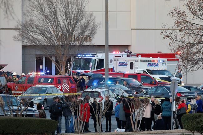 Bystanders watch as police clear Penn Square Mall following a shooting Thursday, Dec. 19, 2019, in Oklahoma City. One person was shot at the mall during what police are calling a disturbance involving two people. (AP Photo/Sue Ogrocki)