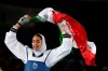 FILE - In this Aug. 18, 2016 file photo, Kimia Alizadeh Zenoorin of Iran celebrates after winning the bronze medal in a women's Taekwondo 57-kg competition at the 2016 Summer Olympics in Rio de Janeiro, Brazil. The defector from Iran who left citing institutional sexism will face the Iranian in the opening bout of their taekwondo class at the Tokyo Olympics. The draw Thursday, July 22, 2021, for the women’s 57-kilogram class placed Kimia Alizadeh of the refugee team against Nahid Kiyani Chandeh of Iran. (AP Photo/Andrew Medichini, File)