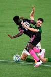 Seattle Sounders defender Yeimar Gomez, left and Portland Timbers forward Jaroslaw Niezgoda compete for the ball during the first half of an MLS soccer match in Portland, Ore., Wednesday, Sept. 23, 2020. (AP Photo/Steve Dykes)